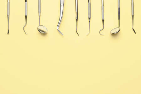 Dentist's tools on color background