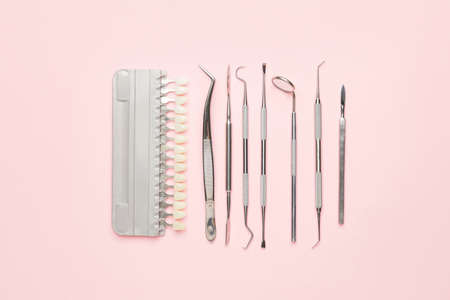 Dentist's tools and teeth samples on color backgroundの写真素材