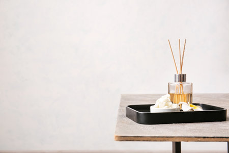 Aroma oil diffuser with shea butter on table