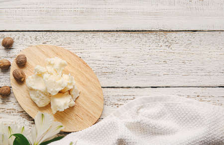 Board with shea butter on table