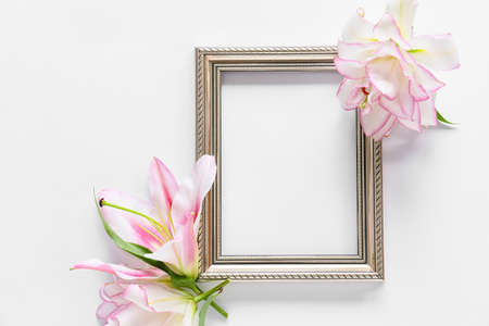 Beautiful lilies and frame on white backgroundの写真素材
