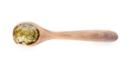 Spoon with tasty pesto sauce on white backgroundの写真素材