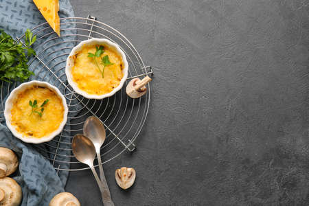 Ramekins with tasty julienne and ingredients on dark backgroundの写真素材