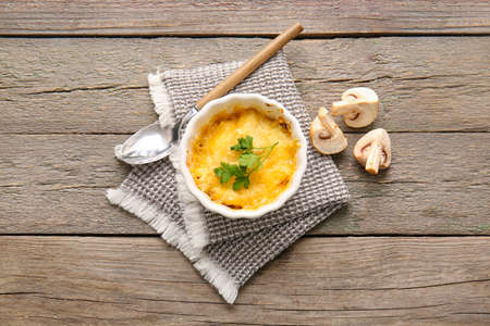 Ramekin with tasty julienne on wooden backgroundの写真素材
