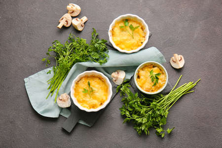 Ramekins with tasty julienne and ingredients on dark backgroundの写真素材