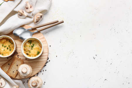 Ramekins with tasty julienne and ingredients on light backgroundの写真素材