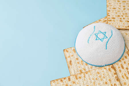 Jewish flatbread matza for Passover and cap on color backgroundの写真素材