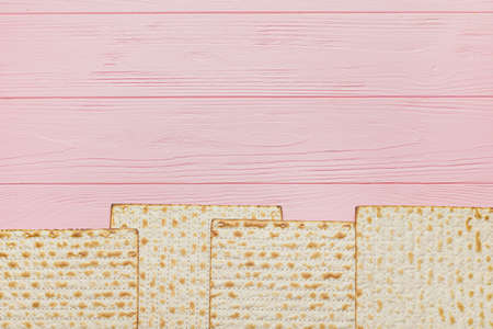 Jewish flatbread matza for Passover on wooden background