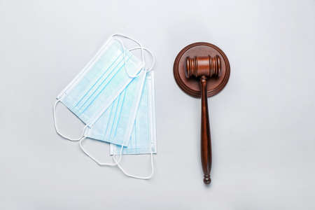 Judge gavel and masks on white background. Concept of health care reform