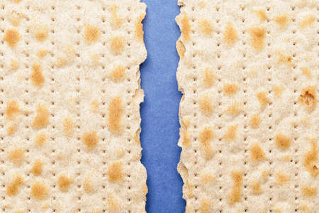 Broken Jewish flatbread matza for Passover on color background, closeupの写真素材