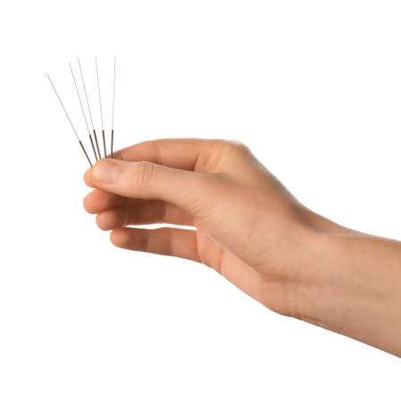 Hand with acupuncture needles on white backgroundの写真素材