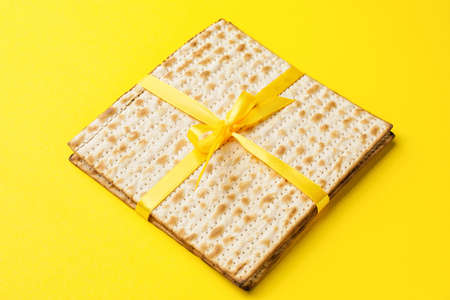 Jewish flatbread matza for Passover on color background