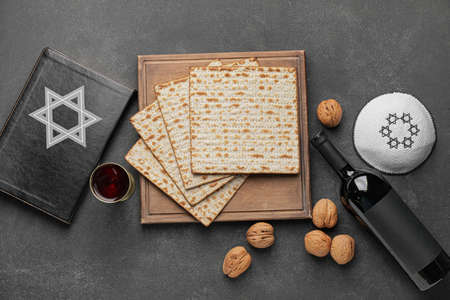 Composition with Jewish flatbread matza for Passover on dark background