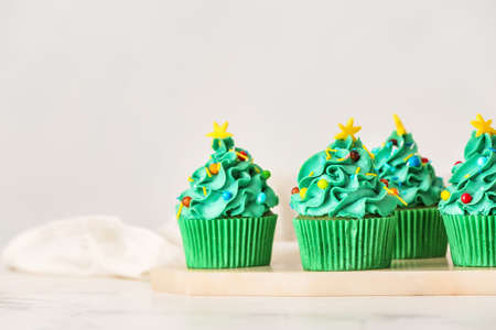 Tasty Christmas cupcakes on tableの写真素材