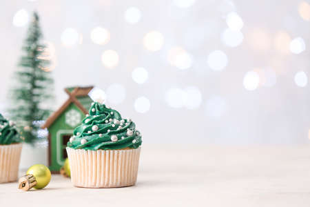 Tasty Christmas cupcakes on tableの写真素材