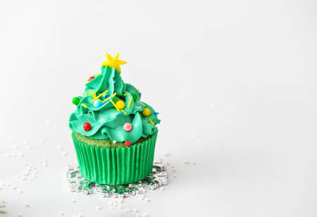 Tasty Christmas cupcake on light backgroundの写真素材
