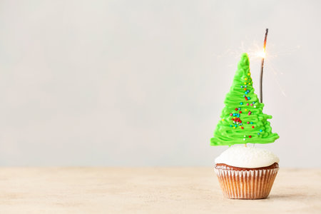 Tasty Christmas cupcake on tableの写真素材