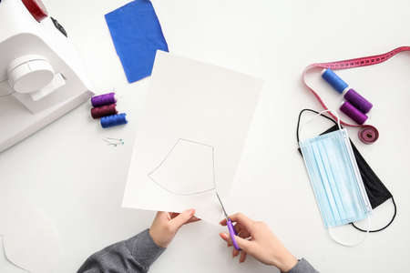 Female tailor making protective masks in workshopの写真素材