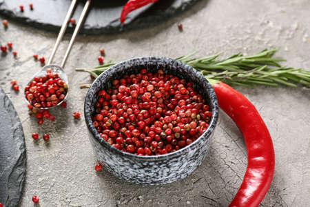 Bowl with red peppercorns on gray backgroundの写真素材