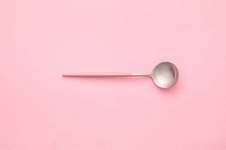 Clean spoon on color background