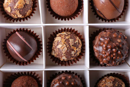Box with sweet chocolate candies, closeup