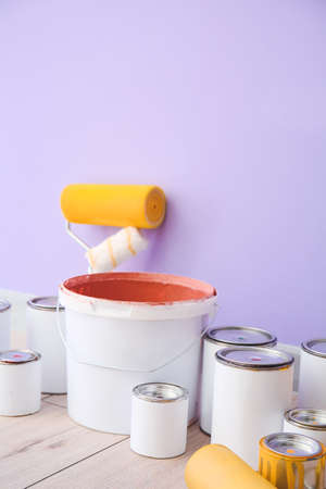 Cans of paints and tools near color wallの写真素材