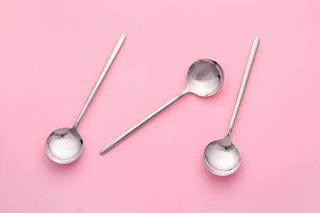 Clean spoons on color backgroundの写真素材