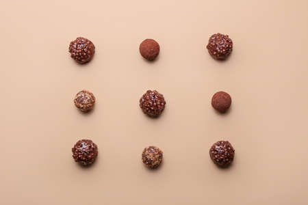 Sweet chocolate candies on color background
