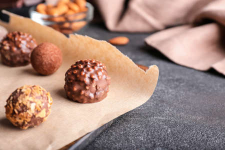 Board with sweet chocolate candies on dark backgroundの写真素材