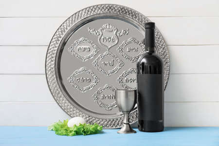 Passover Seder plate with traditional food and wine on table