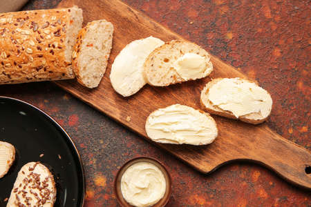 Slices of fresh bread with butter on grunge background