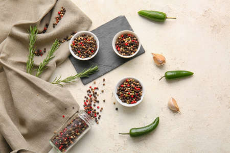 Composition with mixed peppercorns on light backgroundの写真素材