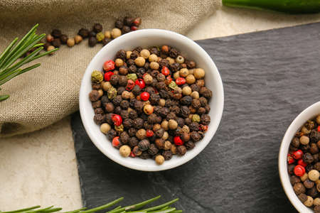 Bowls with mixed peppercorns on table