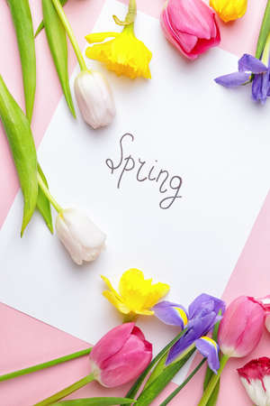 Beautiful flowers and paper with text SPRING on color background