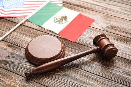 Mexican and USA flags with judge's gavel on wooden background, closeupの写真素材