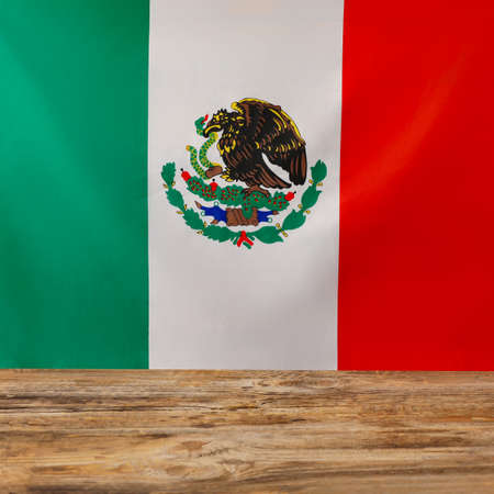 Mexican flag on wooden background, closeup
