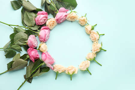 Frame made of beautiful roses on color backgroundの写真素材
