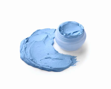 Jar and sample of cosmetic clay on white background