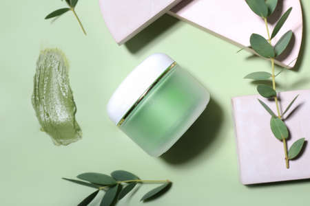 Composition with jar of cosmetic clay on color backgroundの写真素材