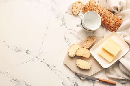 Composition with fresh butter and bread on light backgroundの写真素材
