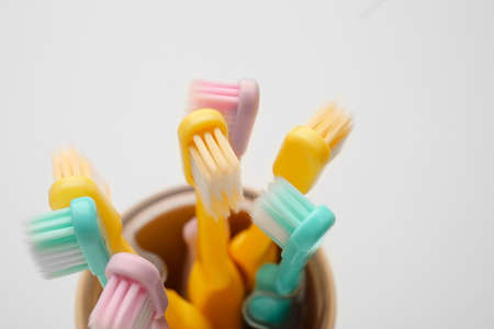 Holder with tooth brushes on white background, closeupの写真素材