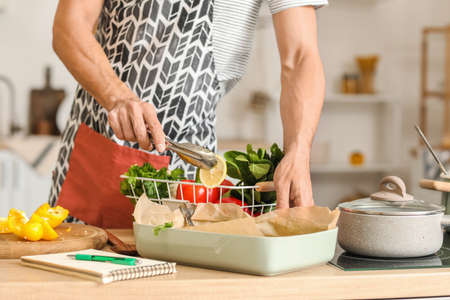 Young man cooking in kitchen