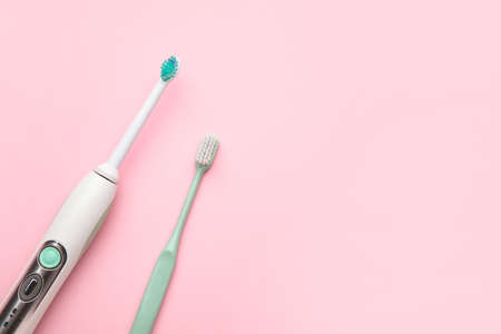 Different tooth brushes on color background