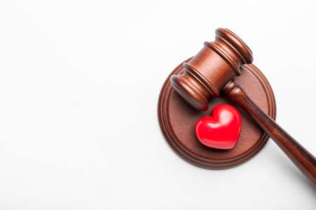 Judge's gavel and heart on white backgroundの写真素材