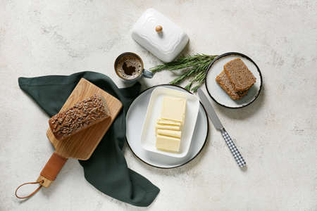 Fresh butter and tasty bread on table
