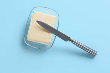 Bowl with fresh butter on color backgroundの写真素材