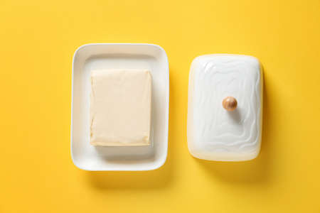 Box with fresh butter on color backgroundの写真素材