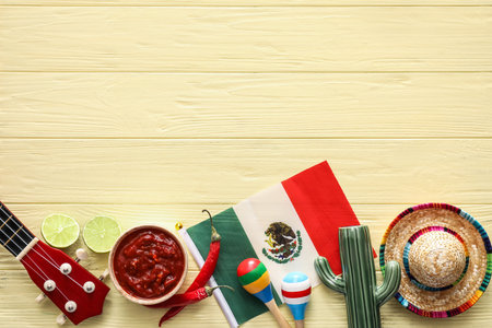 Bowl of tasty salsa sauce with symbols of Mexico on color wooden backgroundの写真素材