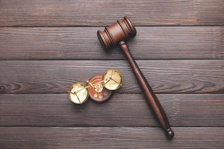 Judge's gavel and justice scales on dark wooden backgroundの写真素材