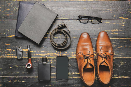 Stylish male accessories and mobile phone on dark wooden backgroundの写真素材